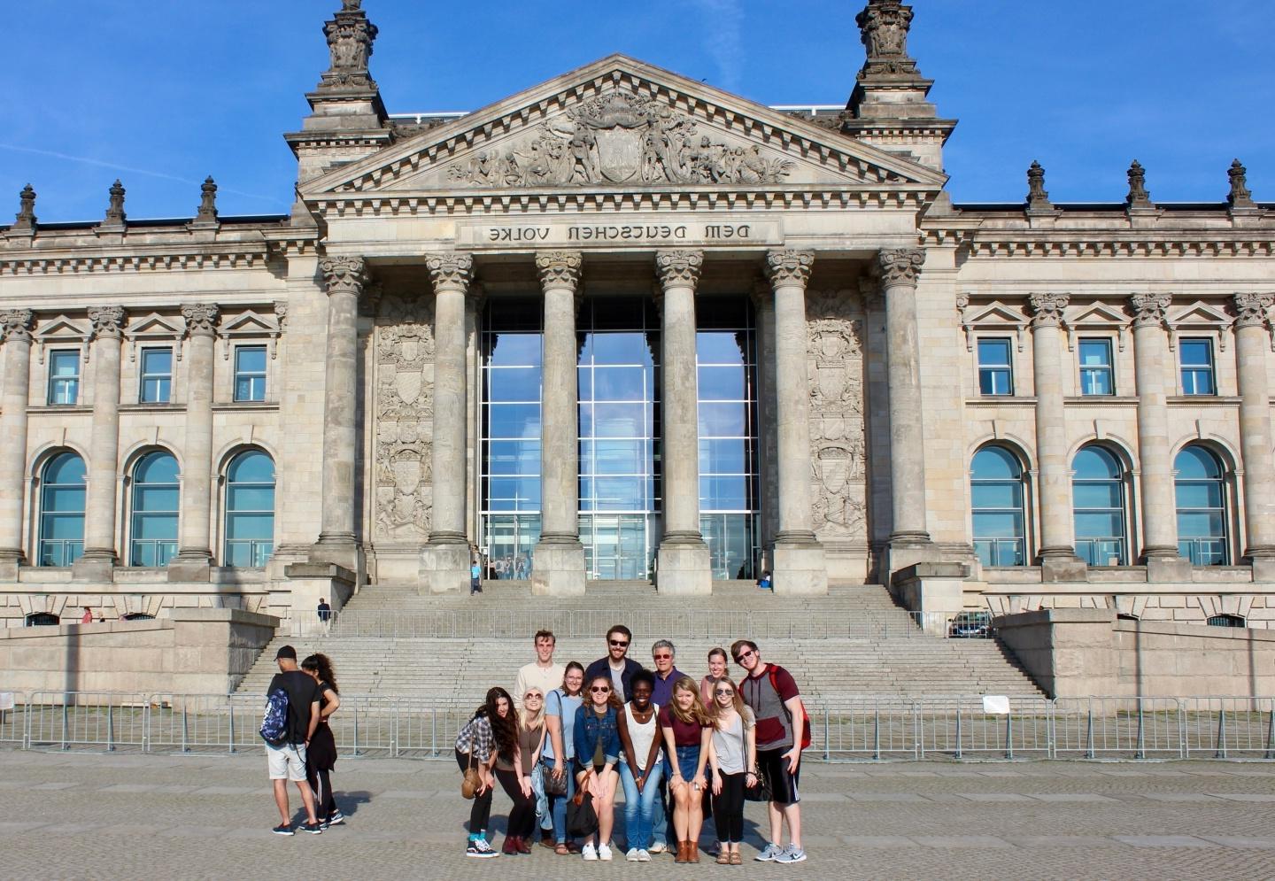 Student group posing in front of the Reichstag building in Berlin, Germany.